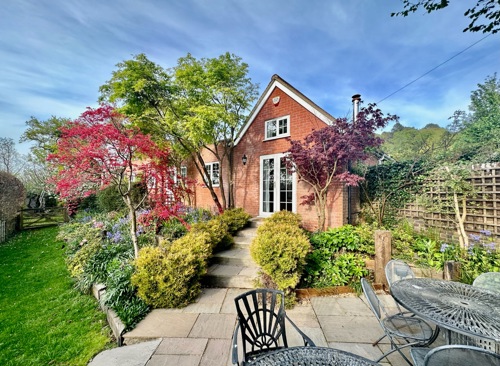 Patio with a cottage in the background